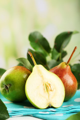 Fresh pears on napkin on blurred background