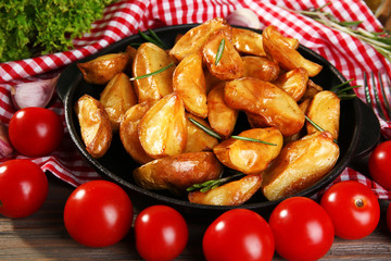 Baked potato wedges on checkered napkin, closeup