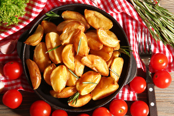 Baked potato wedges on checkered napkin, top view