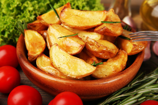 Baked potato wedges on table, closeup