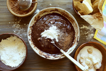 Preparing dough for chocolate pie on table close up