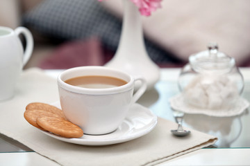Cup of coffee on table in living room