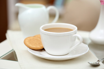 Cup of coffee on table in living room