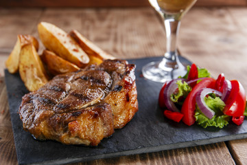 pork steak with fried potatoes and salad