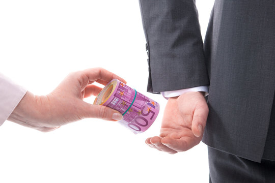 Businessman in a suit takes a bribe