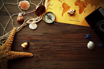 Beautiful composition with sea accessories and camera on table close up