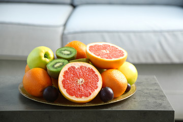 Fresh fruits on table in living room, close up