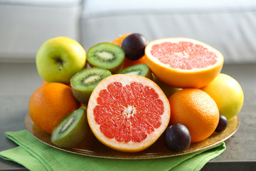 Naklejka na ściany i meble Fresh fruits on table in living room, close up