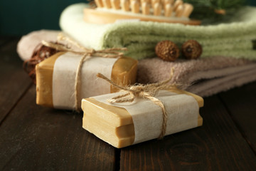 Fototapeta na wymiar Handmade soap and cream with pine extract and spa treatments on wooden background