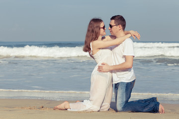 Loving couple standing on the beach at the day time.