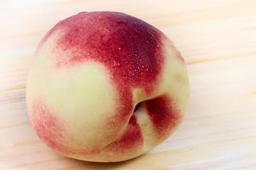 Peach close-up on the wooden background