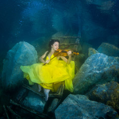 The girl with a violin under water