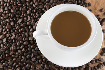 White coffee cup and roasted coffee beans.
