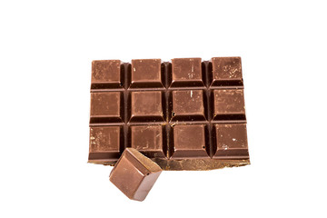 Broken black chocolate bar isolated on white background