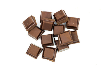 Broken black chocolate bar isolated on white background