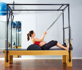 pregnant woman pilates reformer roll up exercise