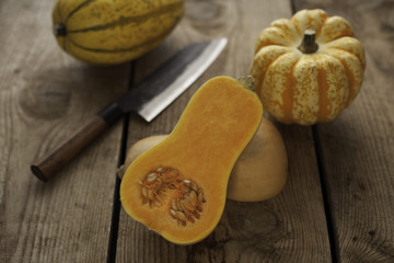 Different pumpkins on wooden surface