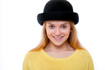 Teenage girl or young woman in yellow sweater and black hat look
