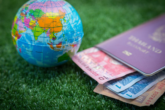 Photo of passport, money and world map.