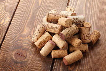 Wine corks heap over rustic wooden table background