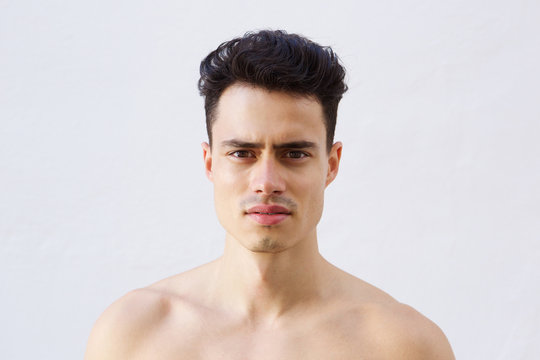 Close up portrait of a handsome young shirtless man