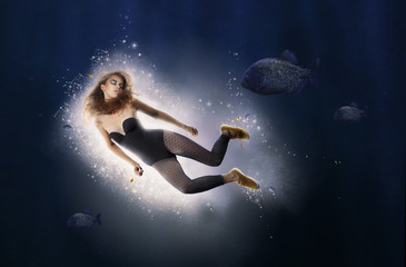 Creativity. Fantasy. Woman is Diving in Water