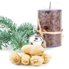 four peanuts in shell and christmas decoration on white background