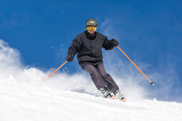 Skier skiing on ski slope