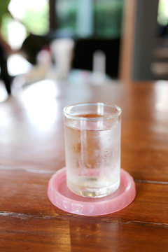 Glass of cold water on a table.