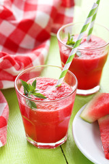 Fresh watermelon juice in the glass on wooden table