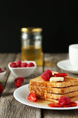 Fresh toast with raspberry and strawberry on grey wooden backgro