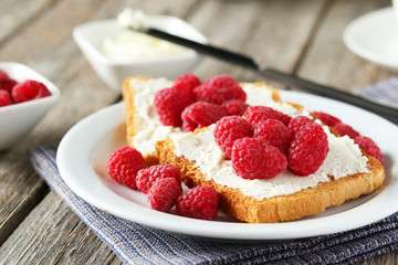 Fresh toast with raspberry on grey wooden background