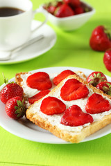 Fresh toast with strawberry on green wooden background
