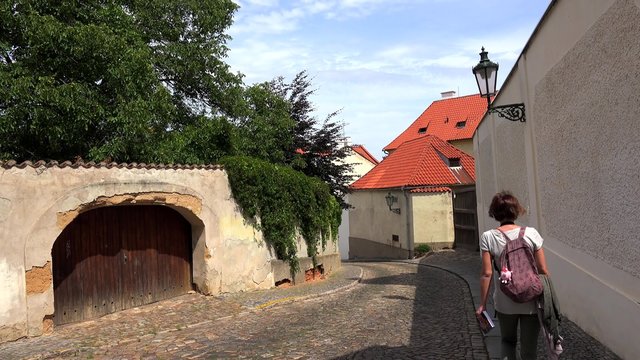 Types of Prague. Tourist at the Hradcany (Kapucinska street). Czech Republic.
