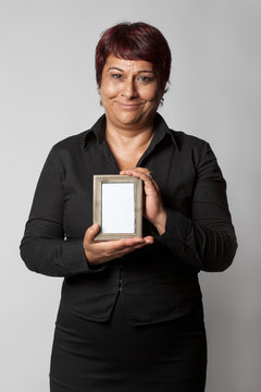 Happy Middle Aged Woman Holding Photo Frame