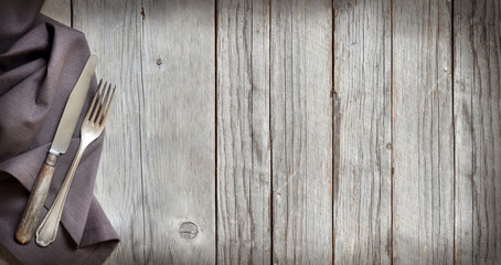 Vintage fork and knife on wood