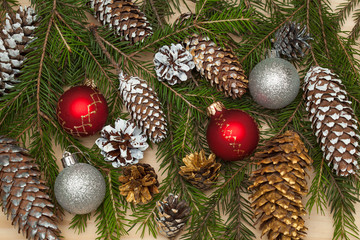 Christmas background, Christmas tree branch with toys and cones. Christmas decorations