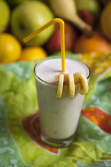 Banana smoothie in a drinking glass.