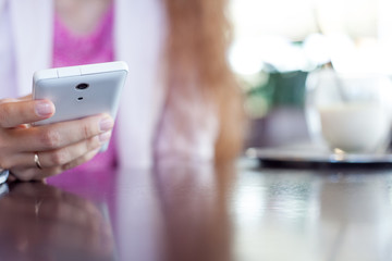 girl holds a smartphone,  small depth of field, soft focus