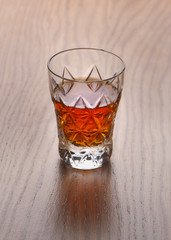 Whiskey, bourbon, brandy, or cognac on log table