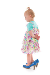 Toddler girl in mothers big shoes