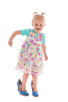 Toddler girl in mothers big shoes