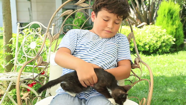 Little boy hugging his pet cat