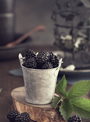 Fototapeta na wymiar Small bucket of blackberry toned