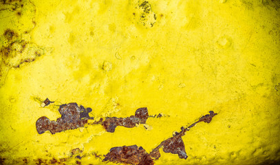 Old rusty metal surface painted with yellow paint, texture, background