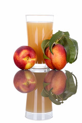 Glass of peach juice with fruit isolated on white.