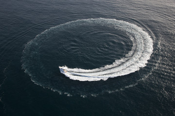 Small yacht making a circle in the water