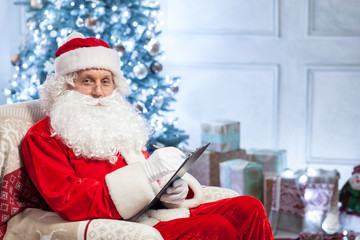 Friendly Santa Claus is preparing for greeting people