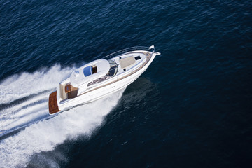 Fast motor boat sailing through an ocean © Image Supply Co