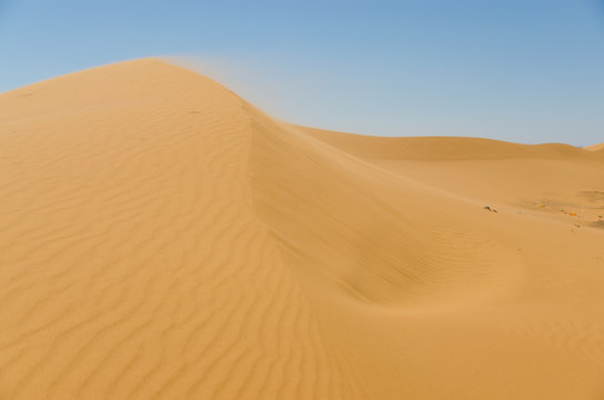 Sahara desert landscape with blue sky. Dunes background.